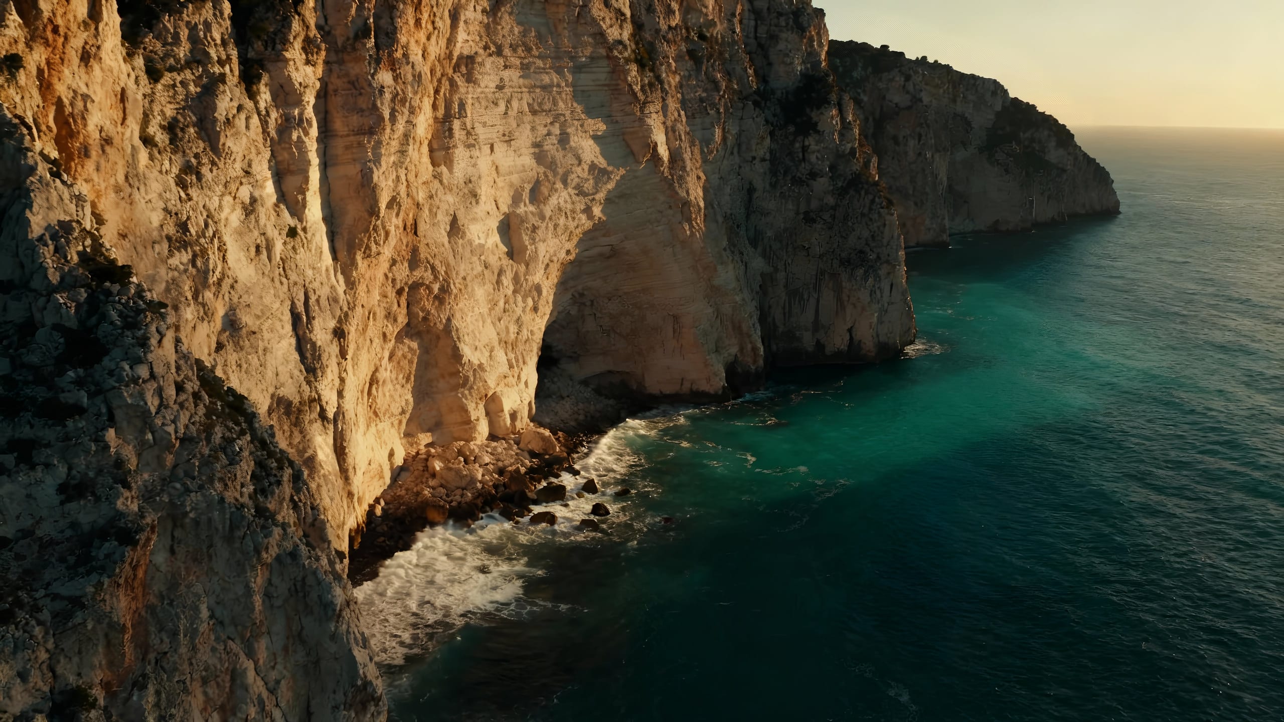Cliffs over the Mediterranean at dusk.