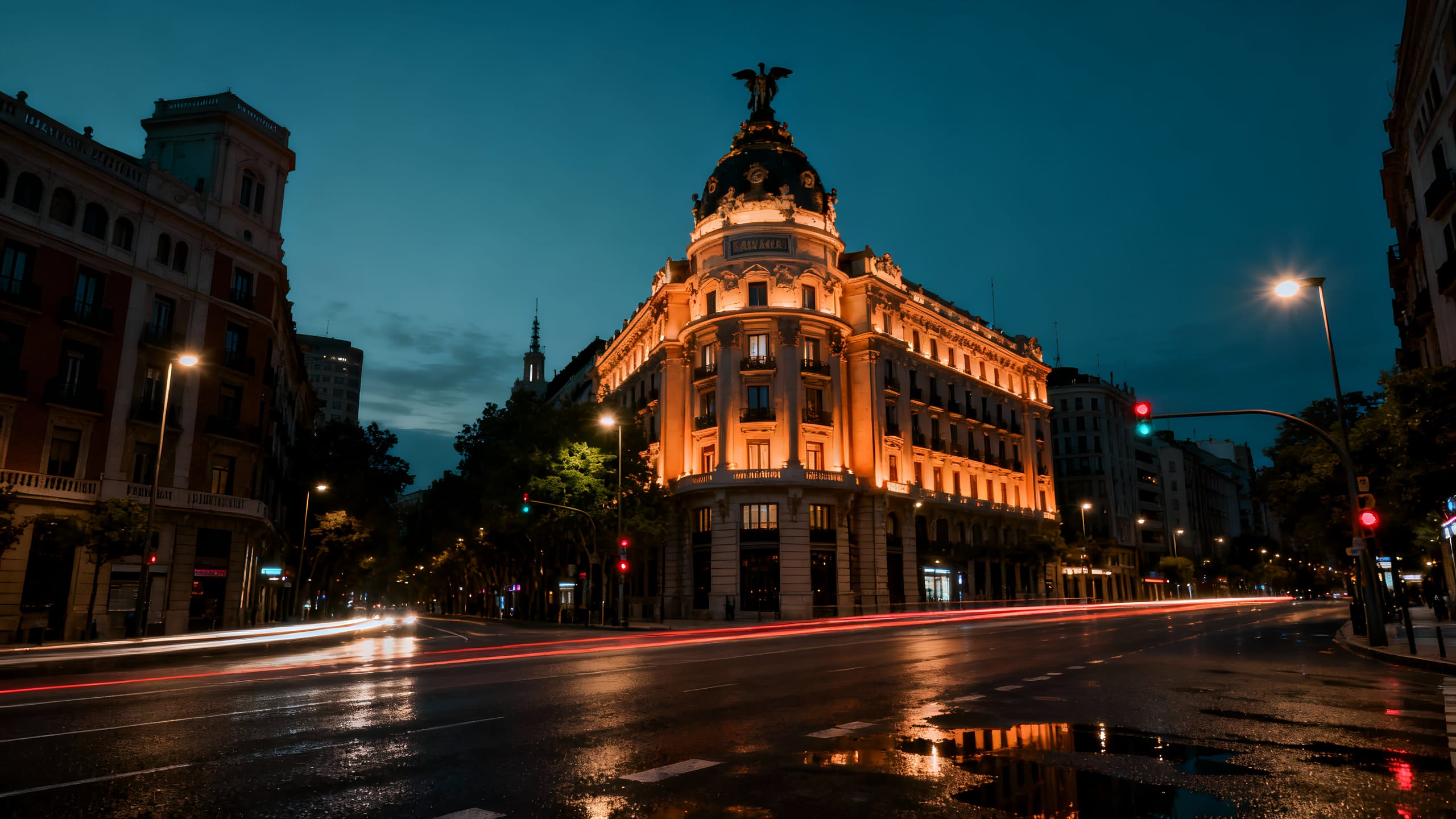 The Metrópolis building lit at night in Madrid.